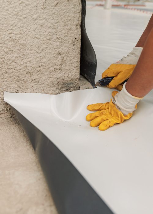 Worker specialized in mounting PVC membranes, TPO in the process of installing a water resistant
