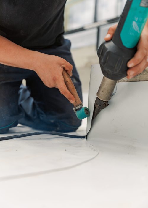 Worker welding pvc  membrane by heater with welder machine