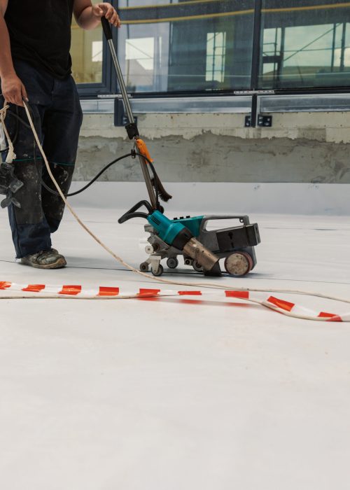 Worker welding pvc  membrane by heater with welder machine