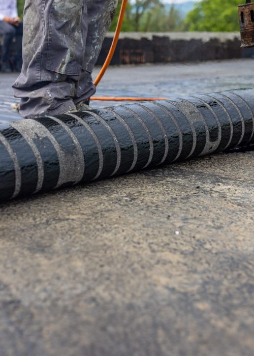 Bituminous membrane waterproofing system details and installation on flat rooftop.