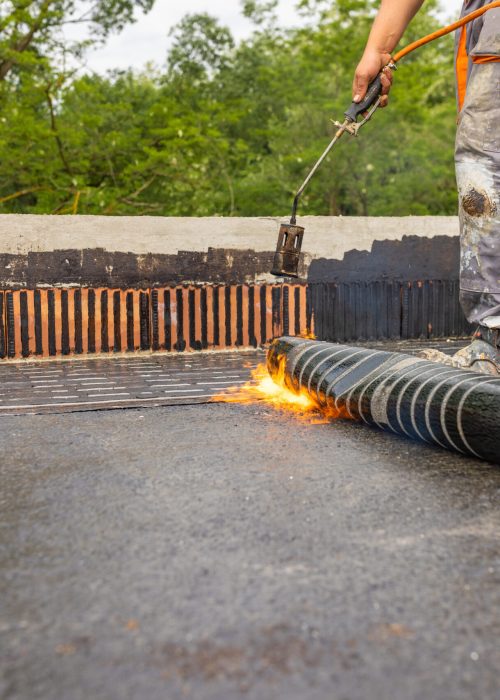 Bituminous membrane waterproofing system details and installation on flat rooftop.