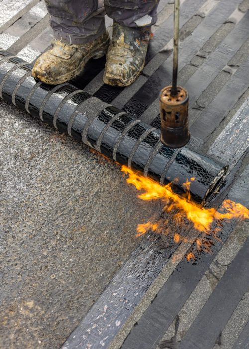 Bituminous membrane waterproofing system details and installation on flat rooftop.